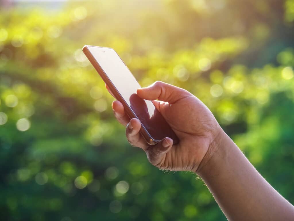 Man using phone outdoor on summer day